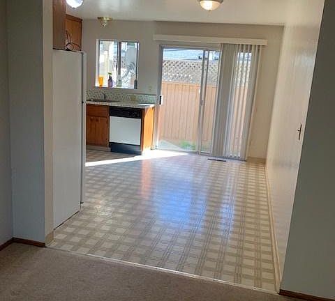 View from living room to kitchen and patio area.