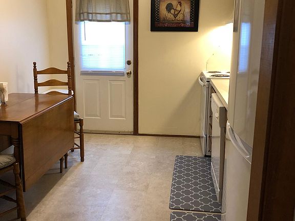Eat-in kitchen with updated appliances (stove, refrigerator), includes dishwasher. Door leads out to 2nd floor deck.