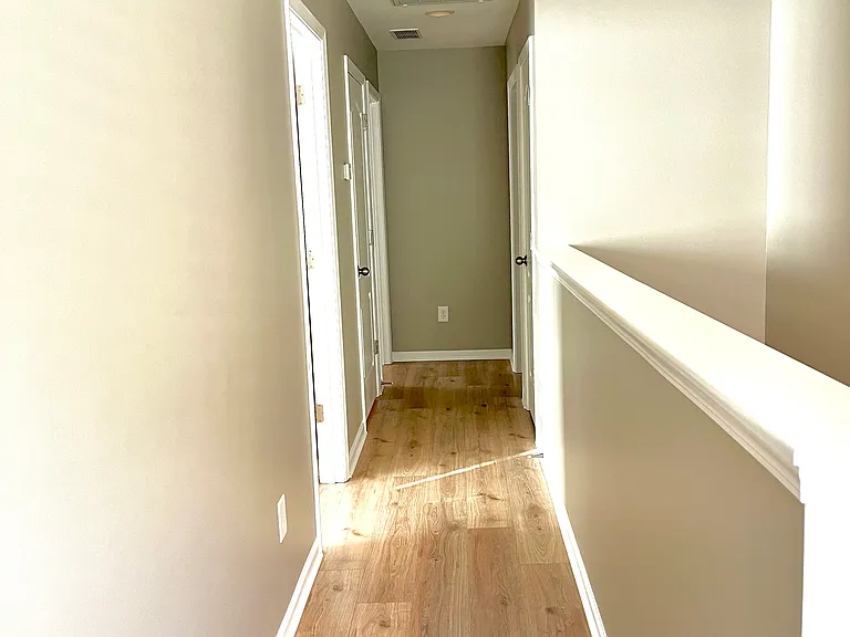 Hallway leading to 3 bedrooms
