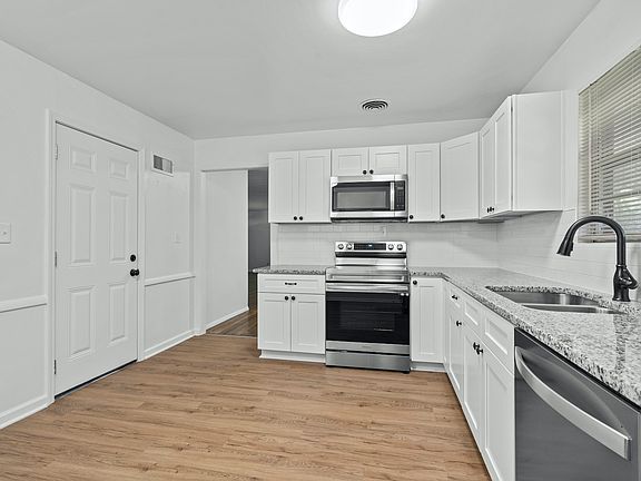 Brand new kitchen with stainless steel appliances (range, refrigerator, dishwasher and microwave).