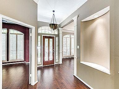 Looking at front door from inside. Den/4th bedroom on left. Formal dining room to the right of front door.