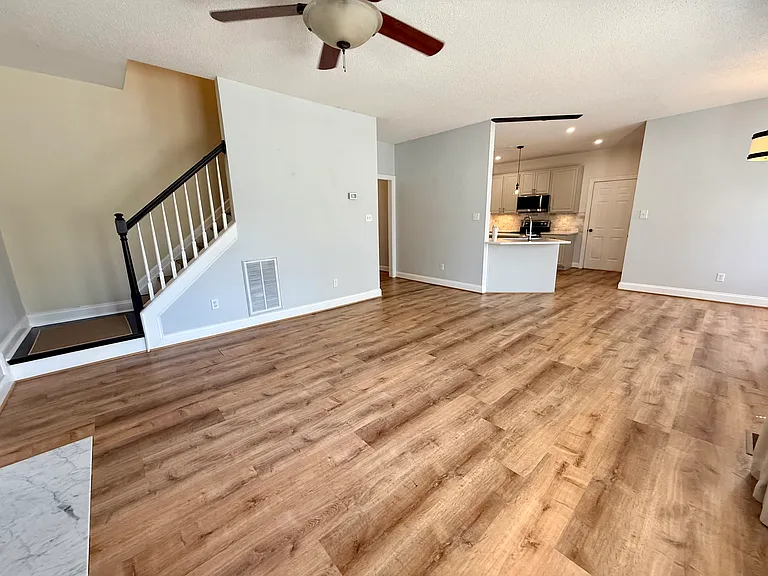 Another picture of the living room showcasing the side entry staircase
