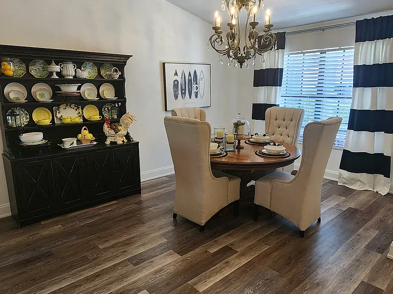 Beautiful round spacious dining room with dimmer switch. Lovely high back chairs for comfort while dining. There are two extra chairs stored for larger groups. You have everything you need here to make a beautiful tablescape. Open to the great room.