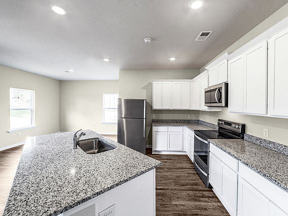 The kitchen is chef-ready with stainless steel appliances