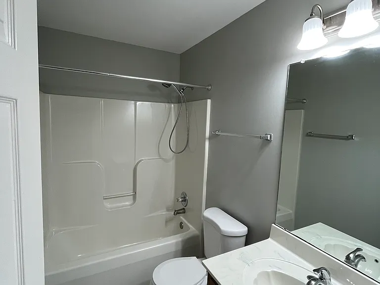 Guest bathroom with vanity and shower/tub.