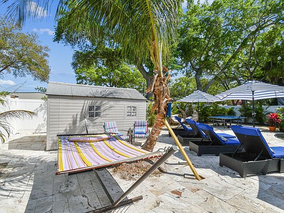 Sway peacefully in the hammock shaded by palms.