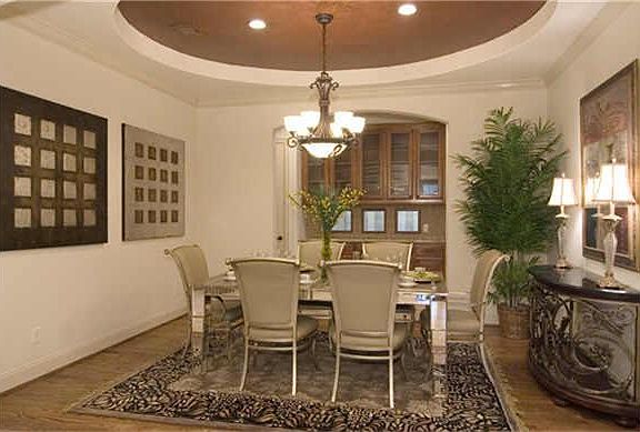 The formal dining room has a unique raised ceiling and is serviced by a butlers pantry.