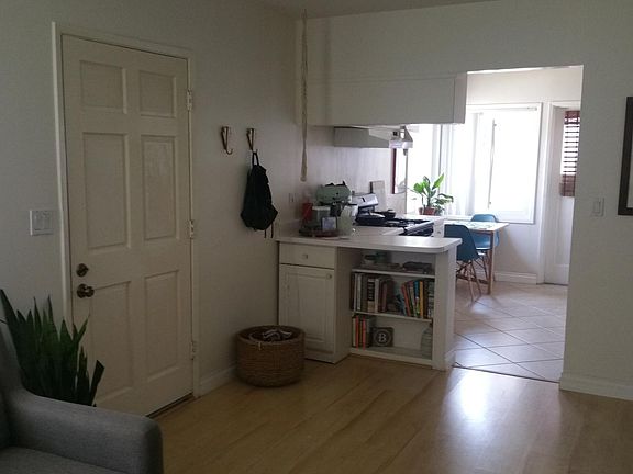 Living room looking at the Front Entry door and to the Kitchen Area