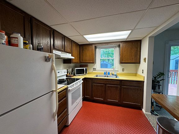 Open-Layout Kitchen with full range oven, fridge, and breakfast barOpen-Layout Kitchen with full range oven, fridge, and breakfast bar