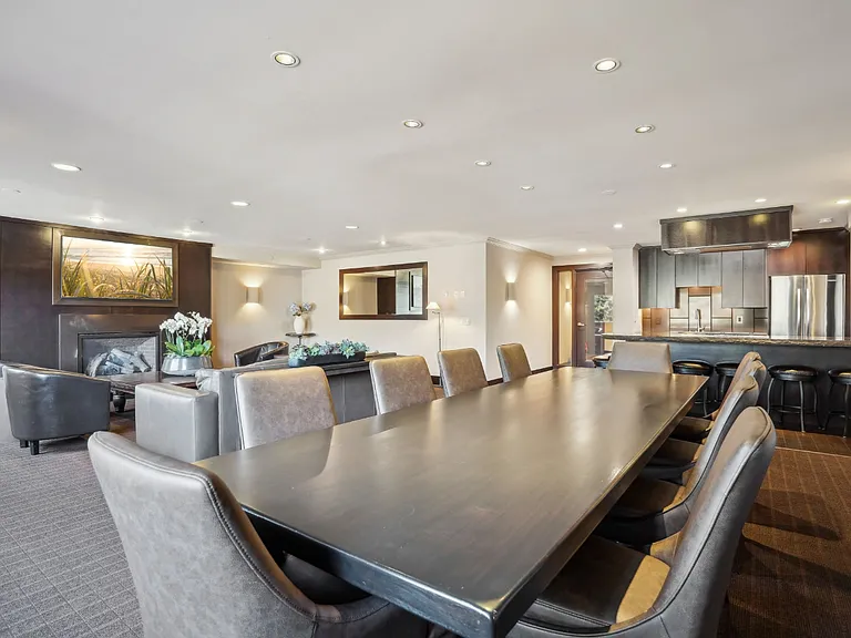 Cedars of Edina clubroom and with conference table and chef style kitchen
