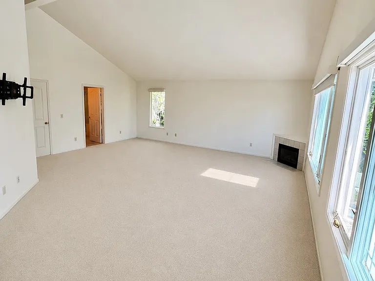 Extra-spacious primary bedroom featuring high ceilings and abundant natural light