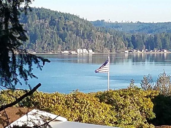 View of Hood Canal looking over neighbor's roof across the street to the right (NW). (zoomed in).