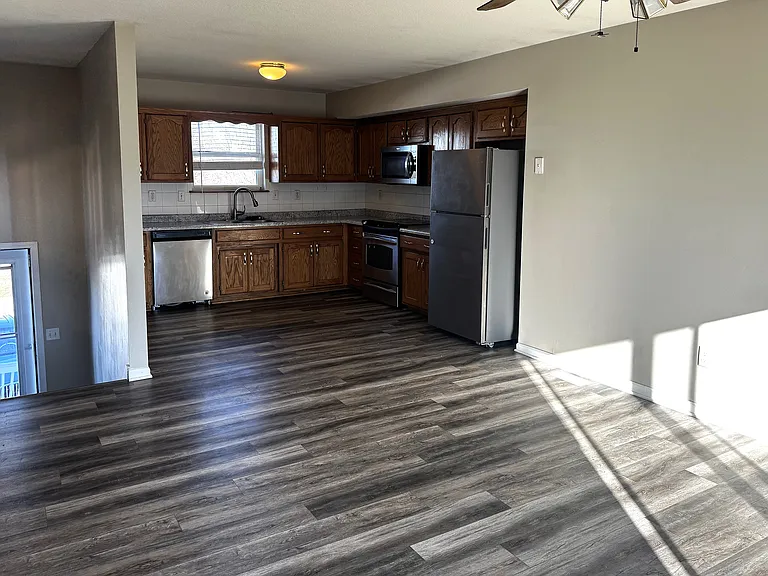 LOOKING AT KITCHEN AND LIVING ROOM