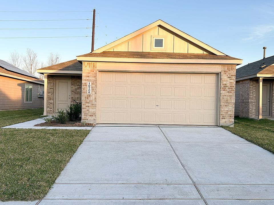 Newly built single-story home with brick exterior, attached two-car garage, and clean, low-maintenance landscaping.