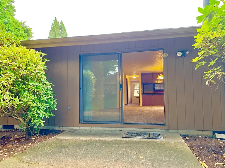 Big rear concrete patio w/faucet and privacy fencing. Established landscaping, large shade trees in rear add privacy and keep patio cool. Patio door is oversized at 8 feet wide! One of the mid-century perks...