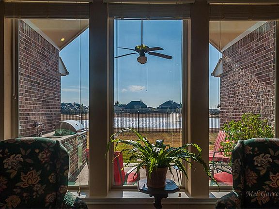 The wall of windows gives a picture perfect view of the lake and fountain behind the home. This is t