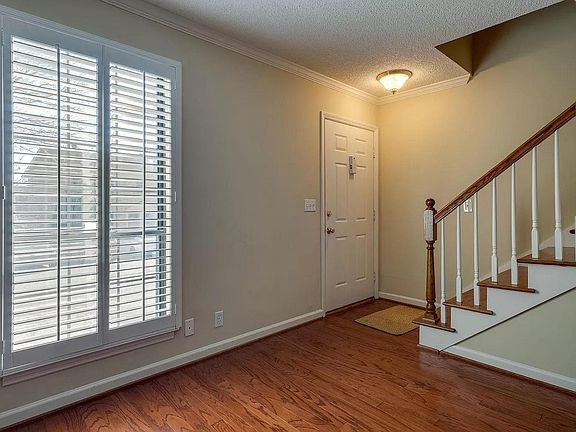 Entrance to the condo from the inside, view is from the living room. Stairs lead to the two bedrooms upstairs.