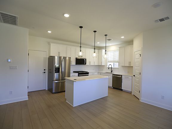 Modern Kitchen: Equipped with brand new Whirlpool appliances, Kitchen Island and a large pantry.