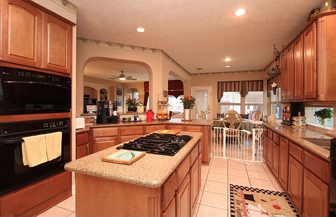 Gourmet island kitchen opens to breakfast room, breakfast bar and living room.