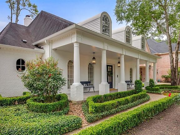 Extensive manicured landscaping surrounds the property.