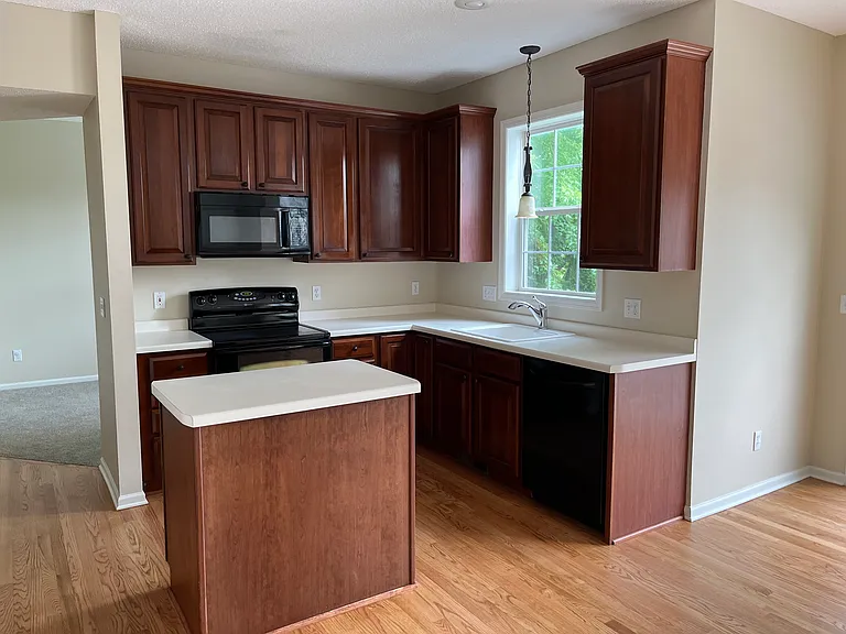 Kitchen with island. The appliances have been changed to stainless steel