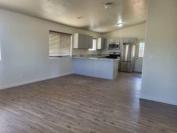 Open floor plan with breakfast bar in kitchen