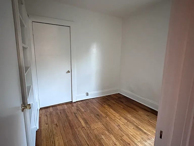 second bedroom with build in bookshelf