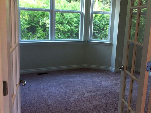 Office with French doors and bay windows. 