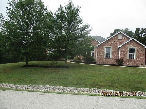 Lovely trees balance out the front landscaped yard.
