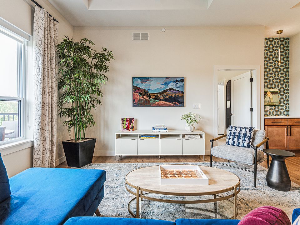 Open and airy living room with large windows overlooking Brucemore
