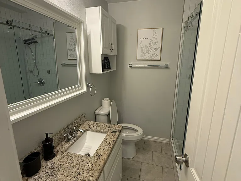 Full Bathroom 1 - walk-in shower and bathroom essentials.