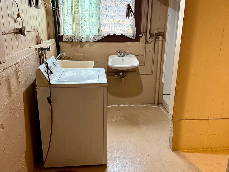 Washer/Dryer Shower Area. (Under renovation currently with new sink and shower/bath being installed.)