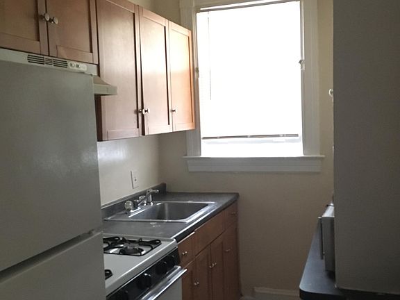 Spacious kitchen with full-sized gas stove and fridge.