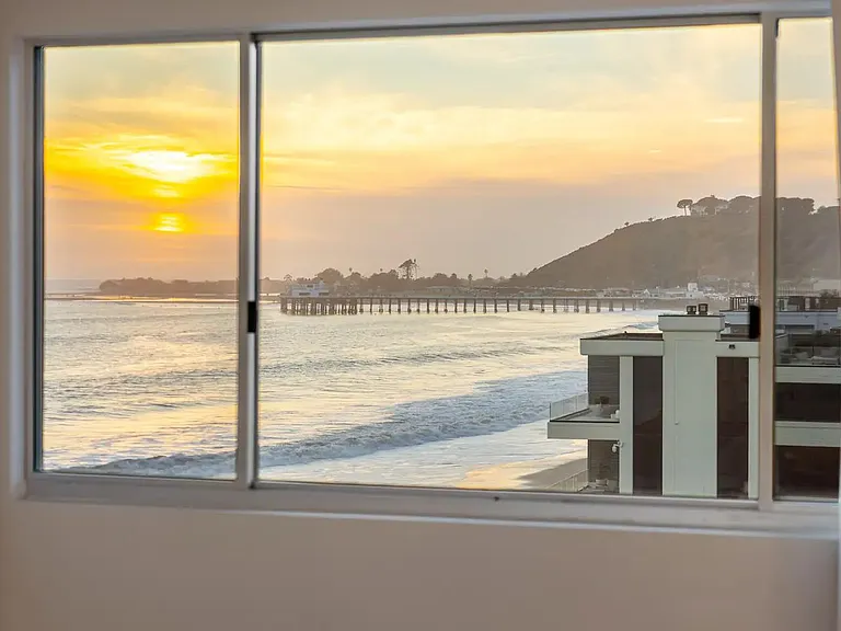 Wind down in the bedroom, where sunset hues set the mood for a peaceful evening.