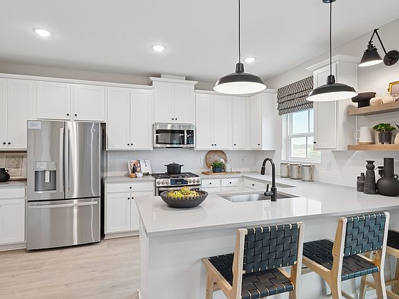 Kitchen with pendant lighting over peninsula island