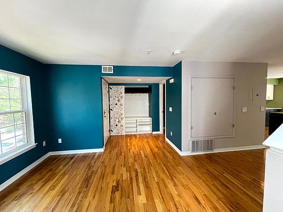 Living space with hallway over to kitchen & dining.