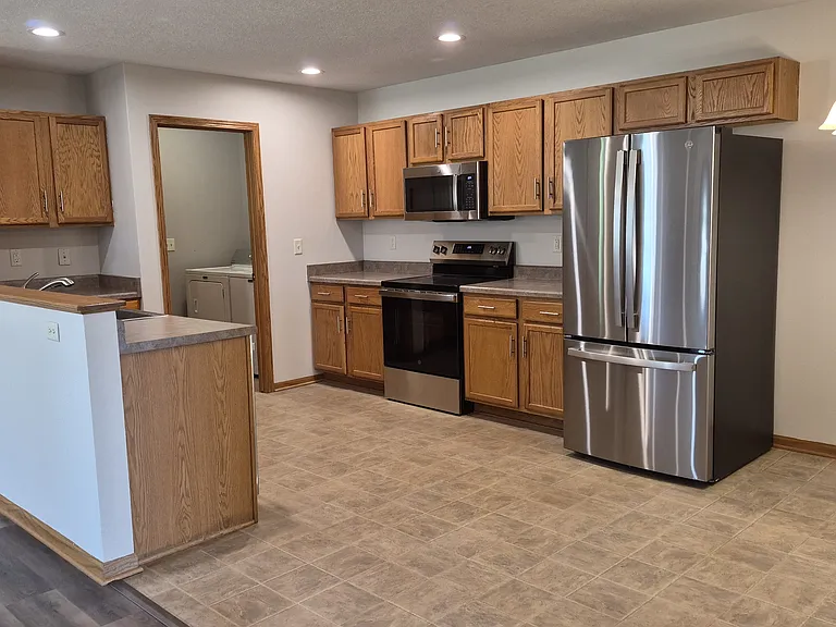 Open kitchen with appliances.