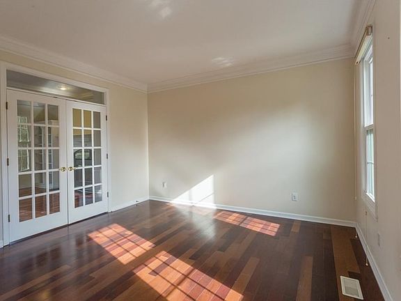 Wonderful den area with same gorgeous hardwoods and crown moulding with French door that open into the family room