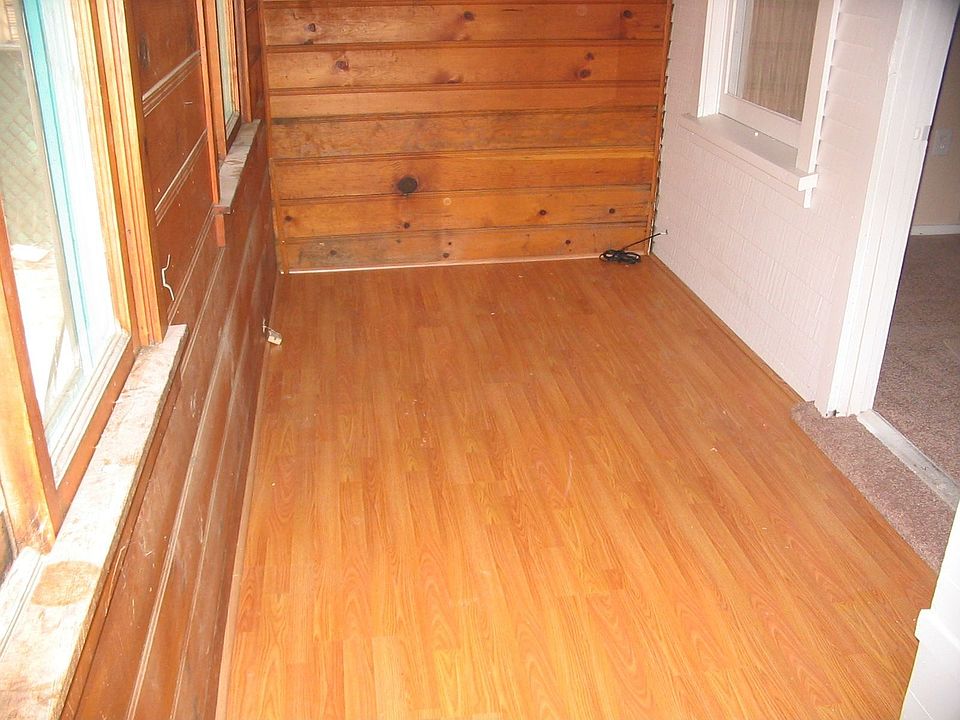 Newly installed laminate wood in entry, kitchen, and utility area.