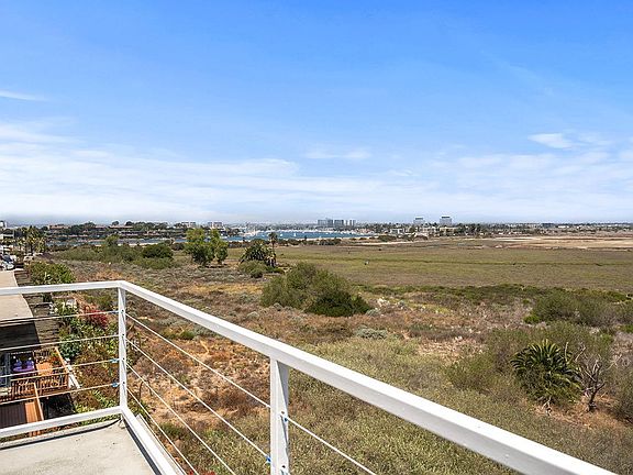 Distant wet land view, can see Hollywood sign on a clear day. City lights at night.