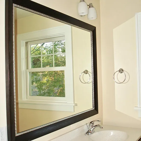 Lots of light, custom framed mirror.