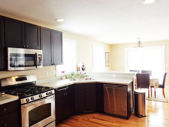 Java maple cabinets make this kitchen really pop. Stainless steel appliances are included.