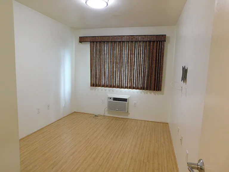 Bedroom. Wall/window a/c. Side draw Roman shades.