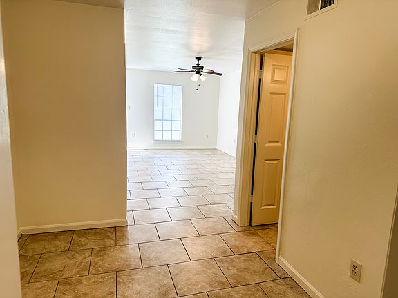 Dining space looking into living area. 1/2 bath to right.