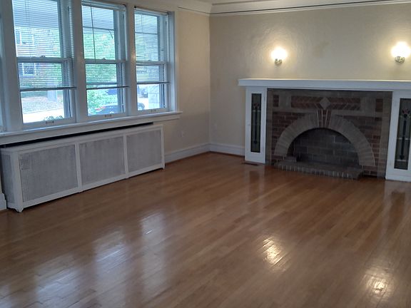 Living room has decorative fireplace and coat closet
