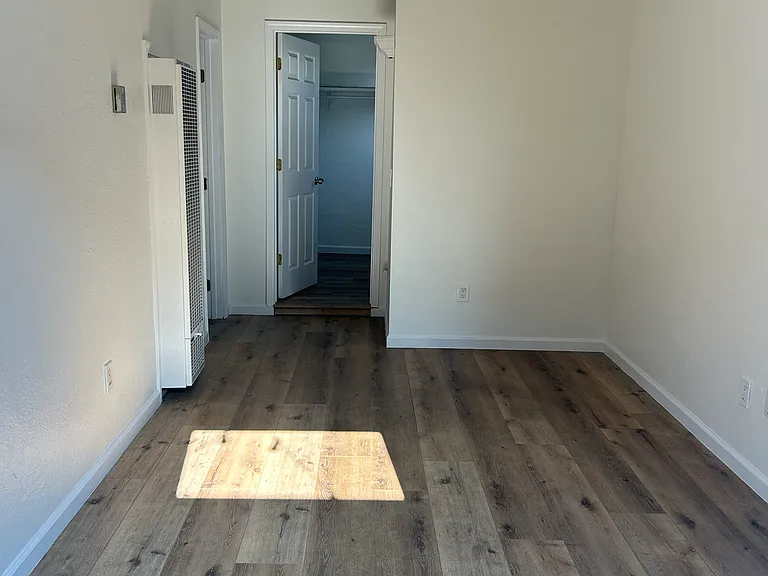 View of Livingroom to door to bedroom, bathroom is on the left