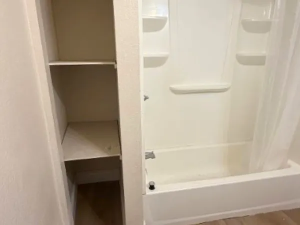 Linen closet by the shower for extra storage