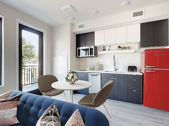 Space-Saving Kitchen with Quartz Counters and Modern Refrigerator