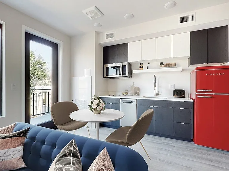 Space-Saving Kitchen with Quartz Counters and Modern Refrigerator
