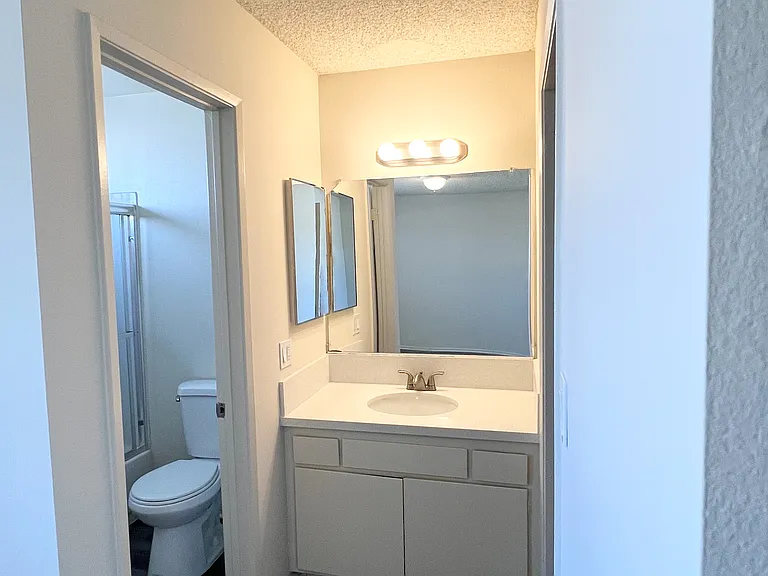 Bathroom and vanity area inside the regular one bedroom unit
